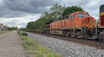 BNSF 3831 and a long string of empties.